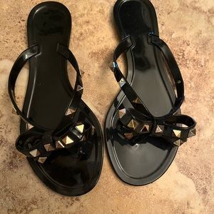 Black studded sandals with bow detail